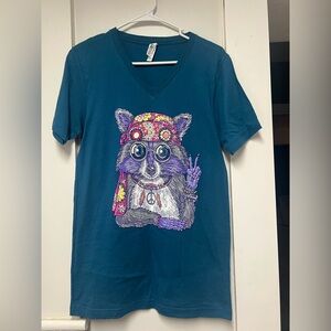Teal Graphic T-Shirt with Peaceful Raccoon Design
